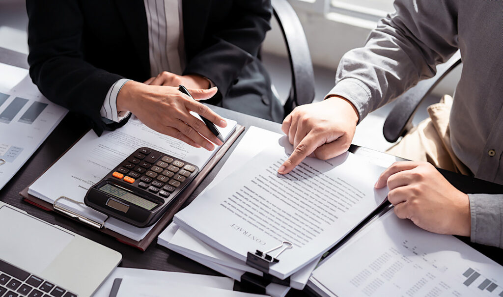 Man and woman discussing and reviewing business insurance plan in Castle Rock, CO